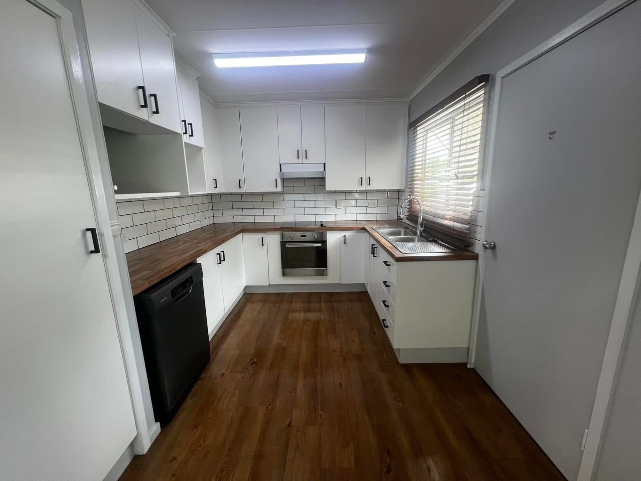 A Dining Room With a Table and Chairs and a Large Window — Miss Bright Cleaning Services In Mount Isa City, QLD