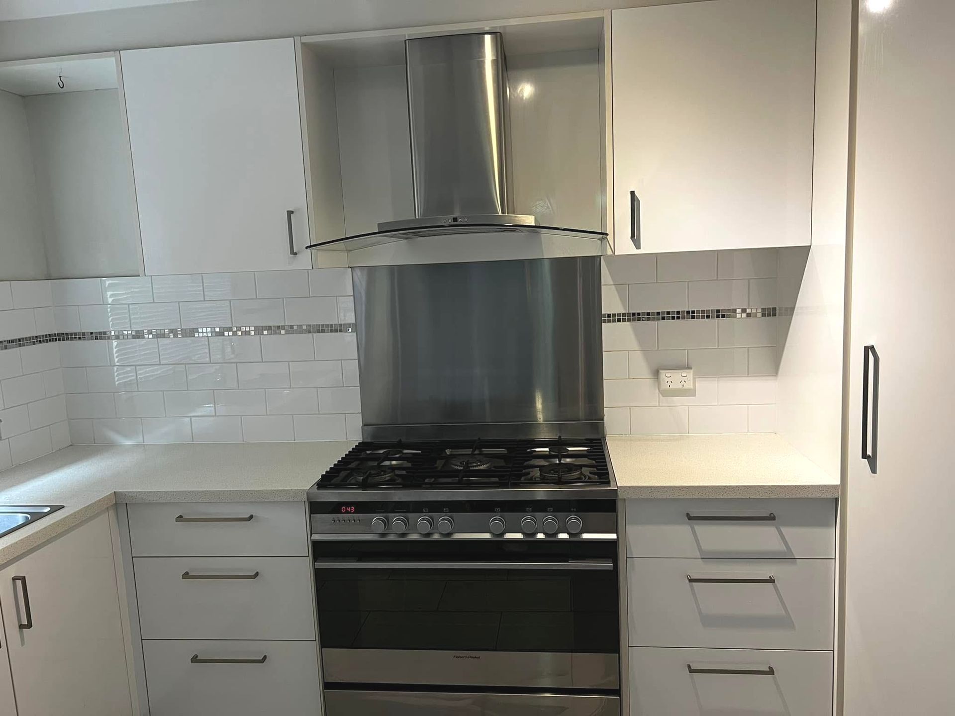 A Kitchen With White Cabinets And Stainless Steel Appliances — Miss Bright Cleaning Services In Mount Isa City, QLD