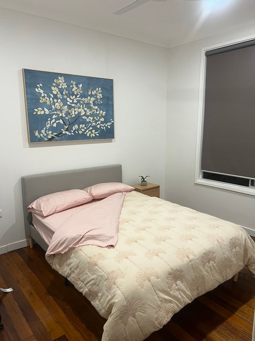 A Bedroom With A Bed And A Painting On The Wall Above It — Miss Bright Cleaning Services In Mount Isa City, QLD