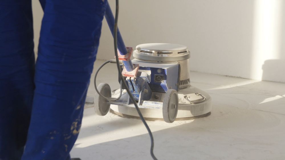 A Person is Using a Machine to Polish a Floor — Miss Bright Cleaning Services In Mount Isa City, QLD