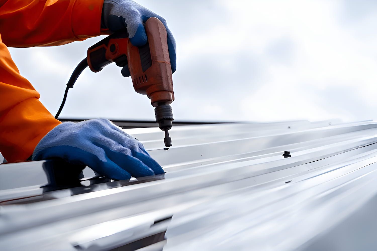 A Man is Using a Drill to Fix a Roof — Ron Nickel Roofing in Tweed Heads South, NSW