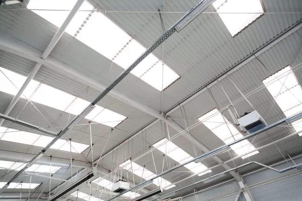 The Ceiling of a Building With a Lot of Windows and Lights — Ron Nickel Roofing in Tweed Heads South, NSW