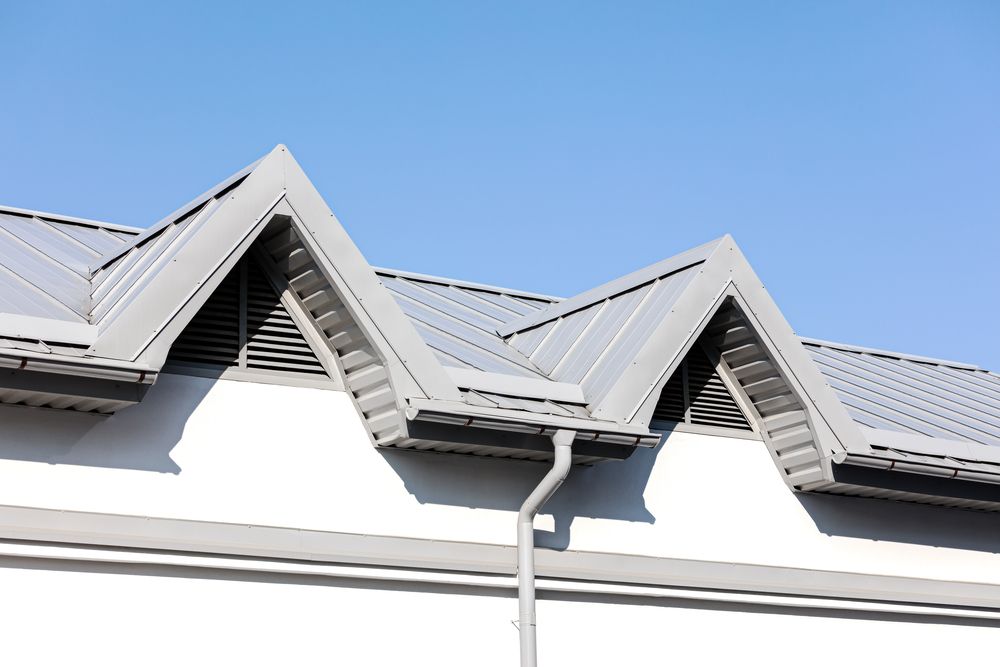 The Roof of a Building With a Gutter and a Blue Sky in the Background — Ron Nickel Roofing in Burleigh Heads, QLD