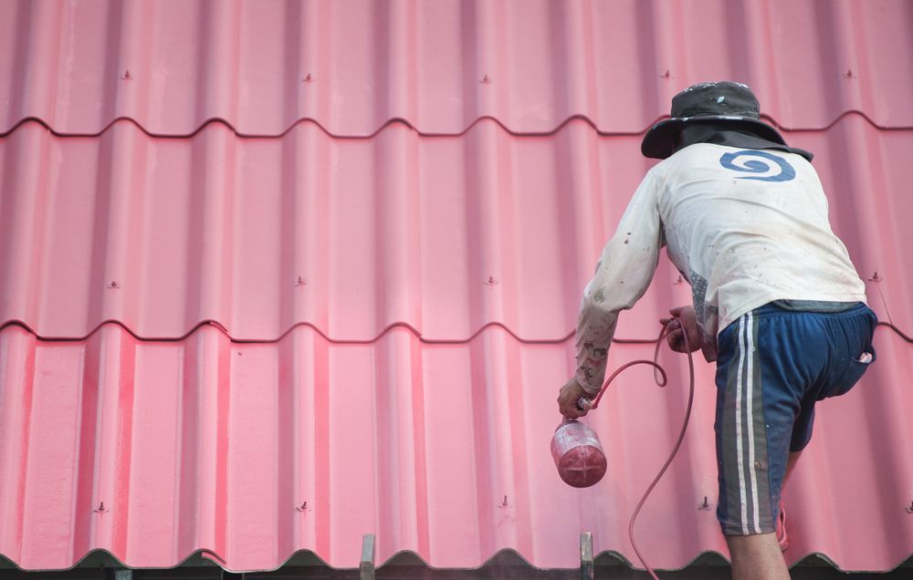 Roofer Painting the Rooftop 