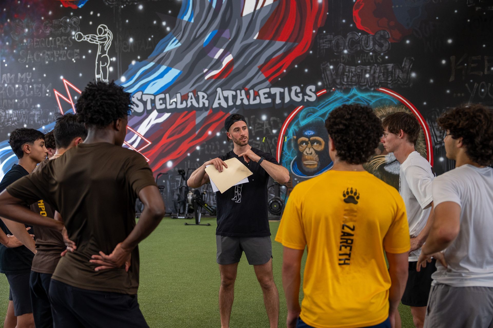 A group of young men are posing for a picture in a gym.