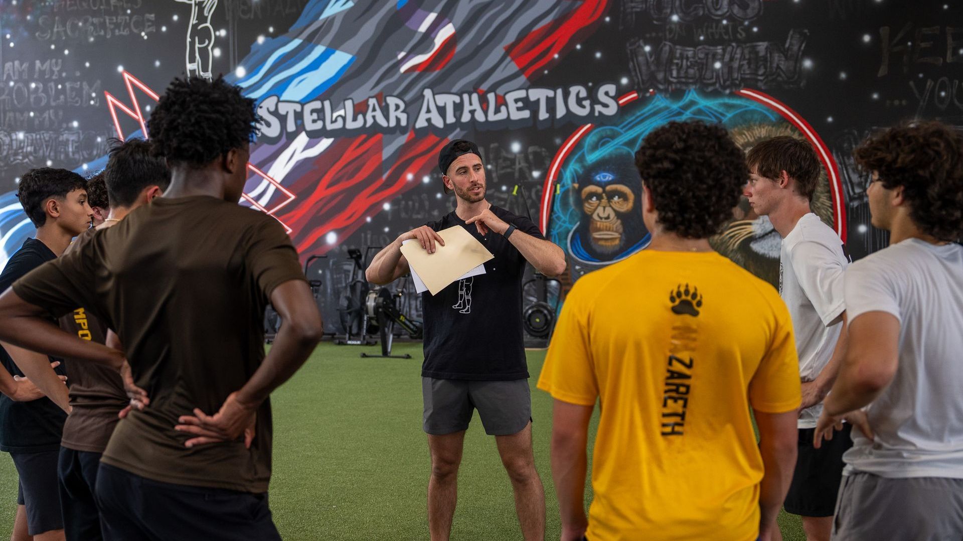 A group of young men are posing for a picture in a gym.