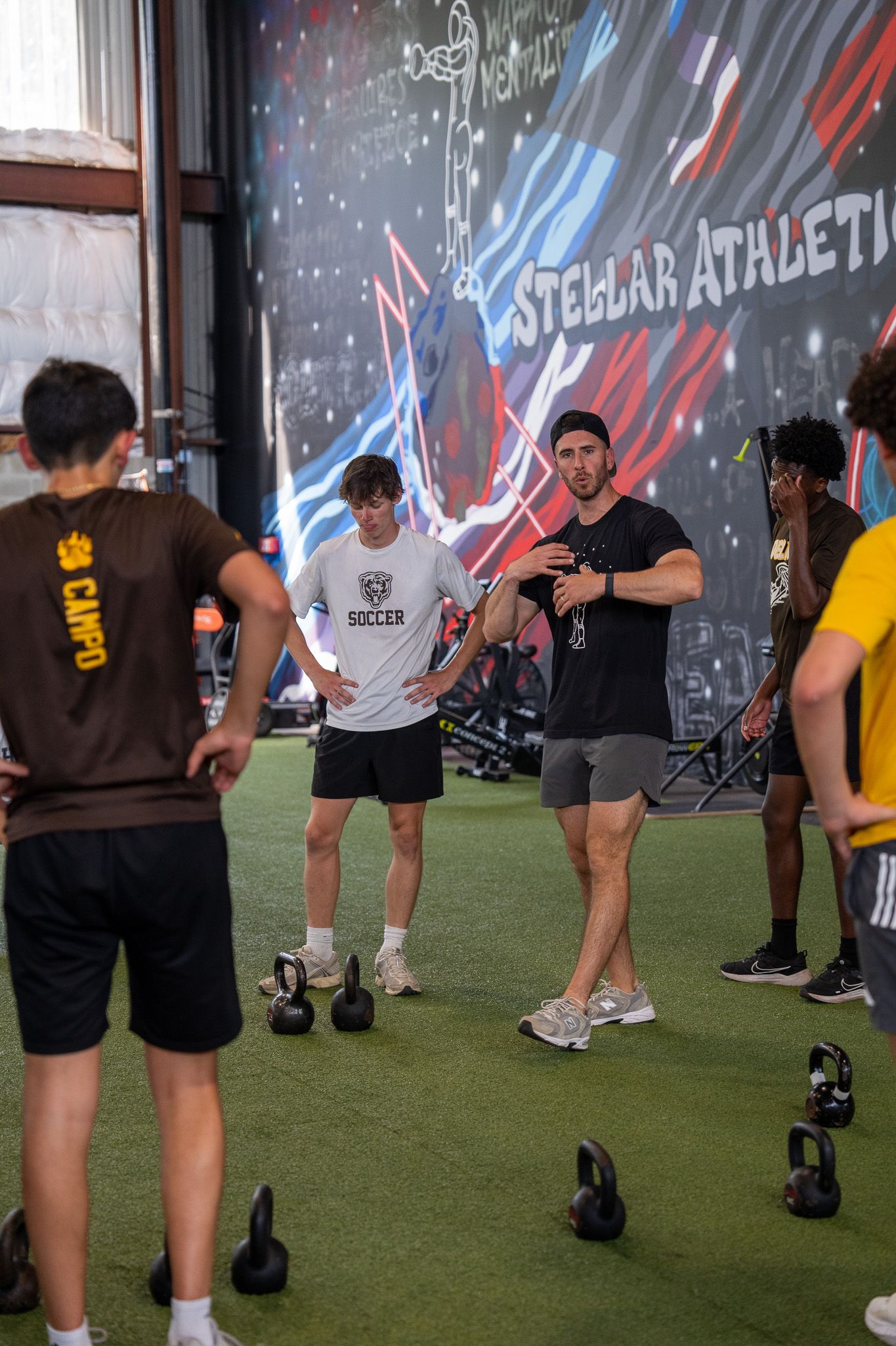 A gym with a lot of dumbbells and benches.
