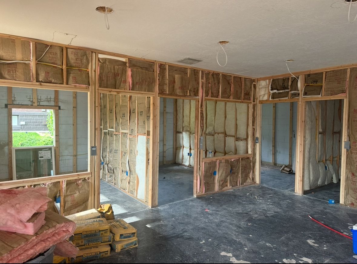 Interior framing with insulation installed.  Rooms under construction, unfinished walls.