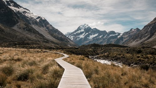 Wooden pathway leading towards the mountains