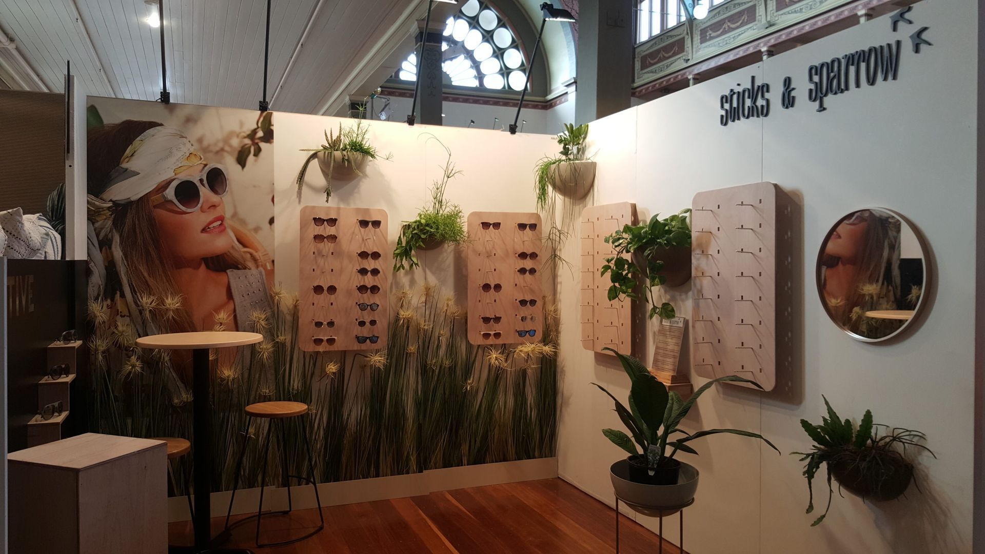 A room with plants and a sign that says shade & sparrow