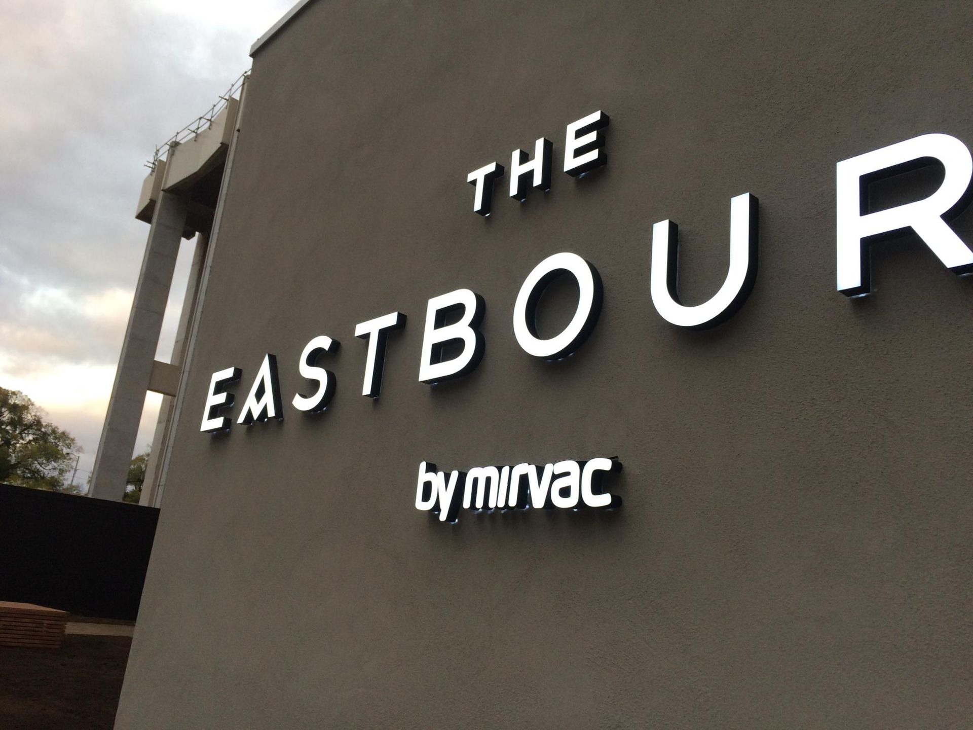 A sign on the side of a building that says the eastbour by mirvac