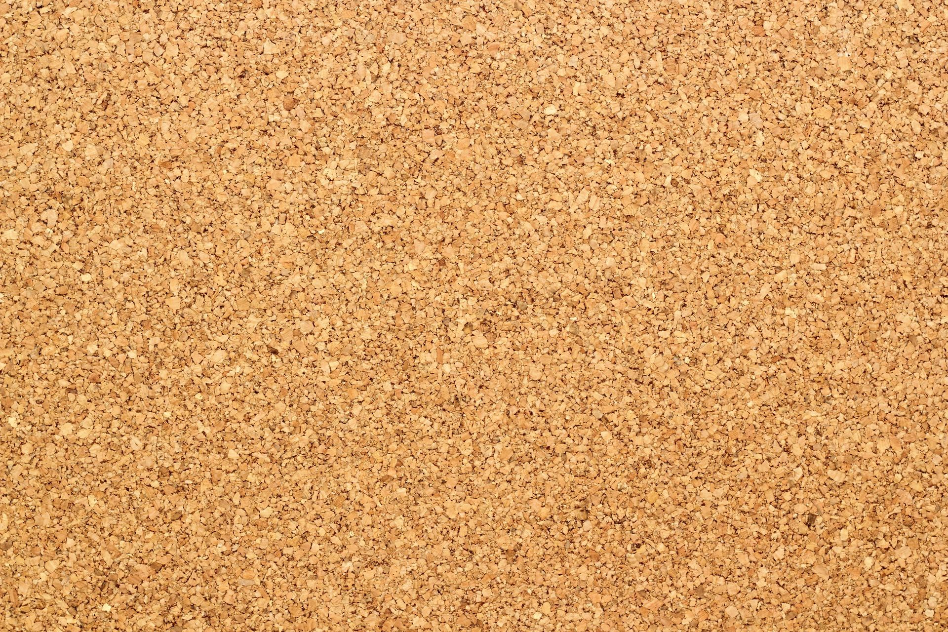 A close up of a cork board showing the texture of the cork.