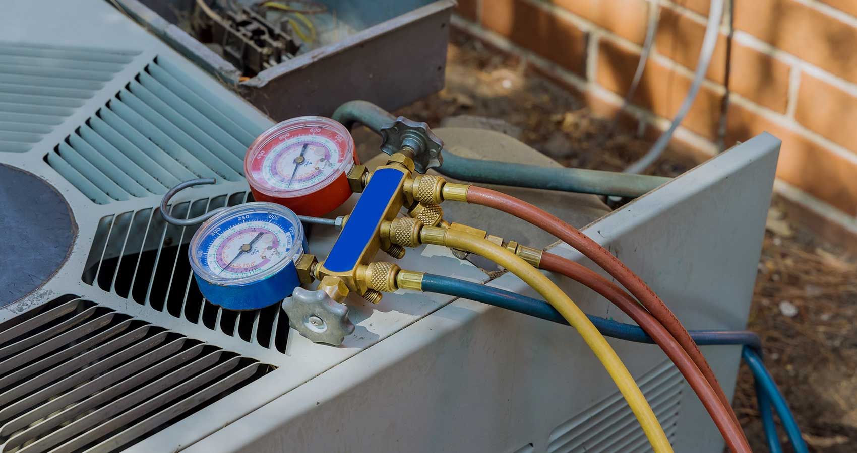 A close up of a gas gauge on top of an air conditioner.