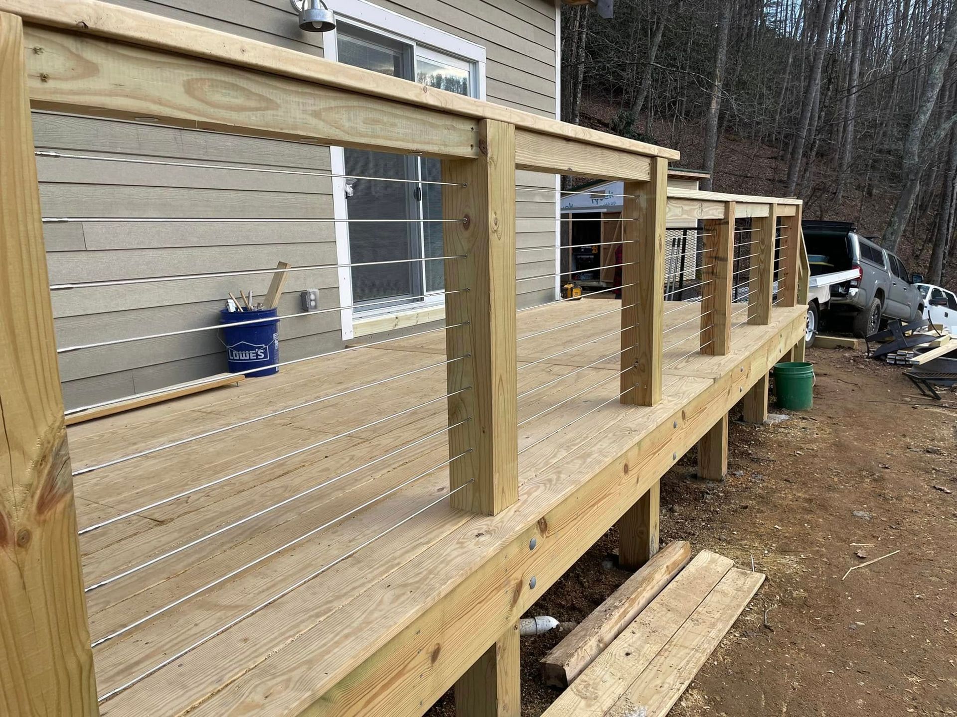 A wooden deck is being built in front of a house.