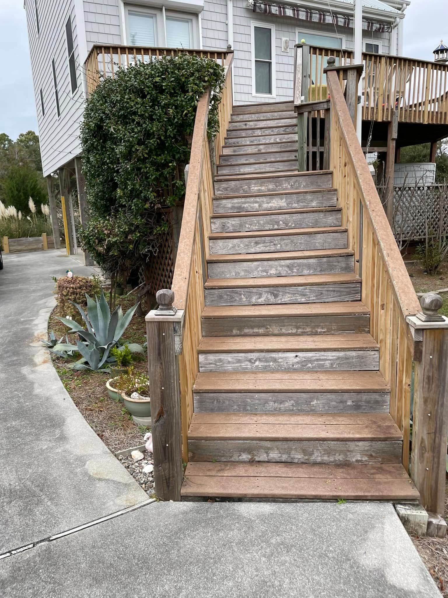 A set of wooden stairs leading up to a house.