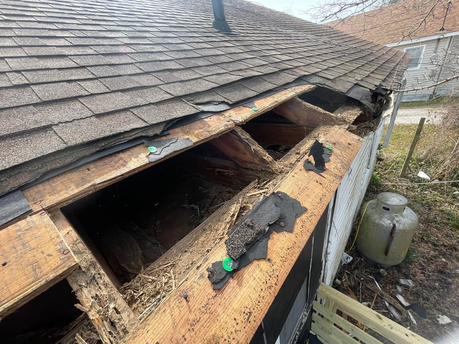 A roof with a hole in it is being repaired.