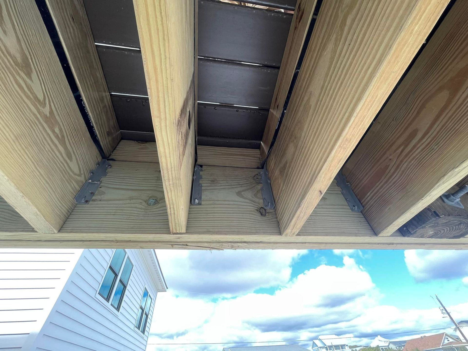 The ceiling of a house is made of wood and metal.