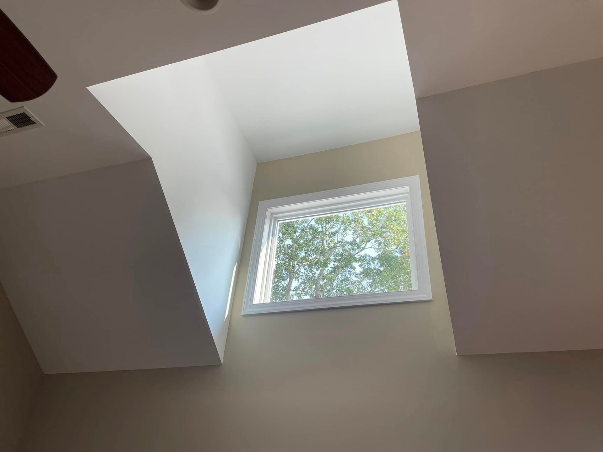 There is a window in the ceiling that looks like a skylight.