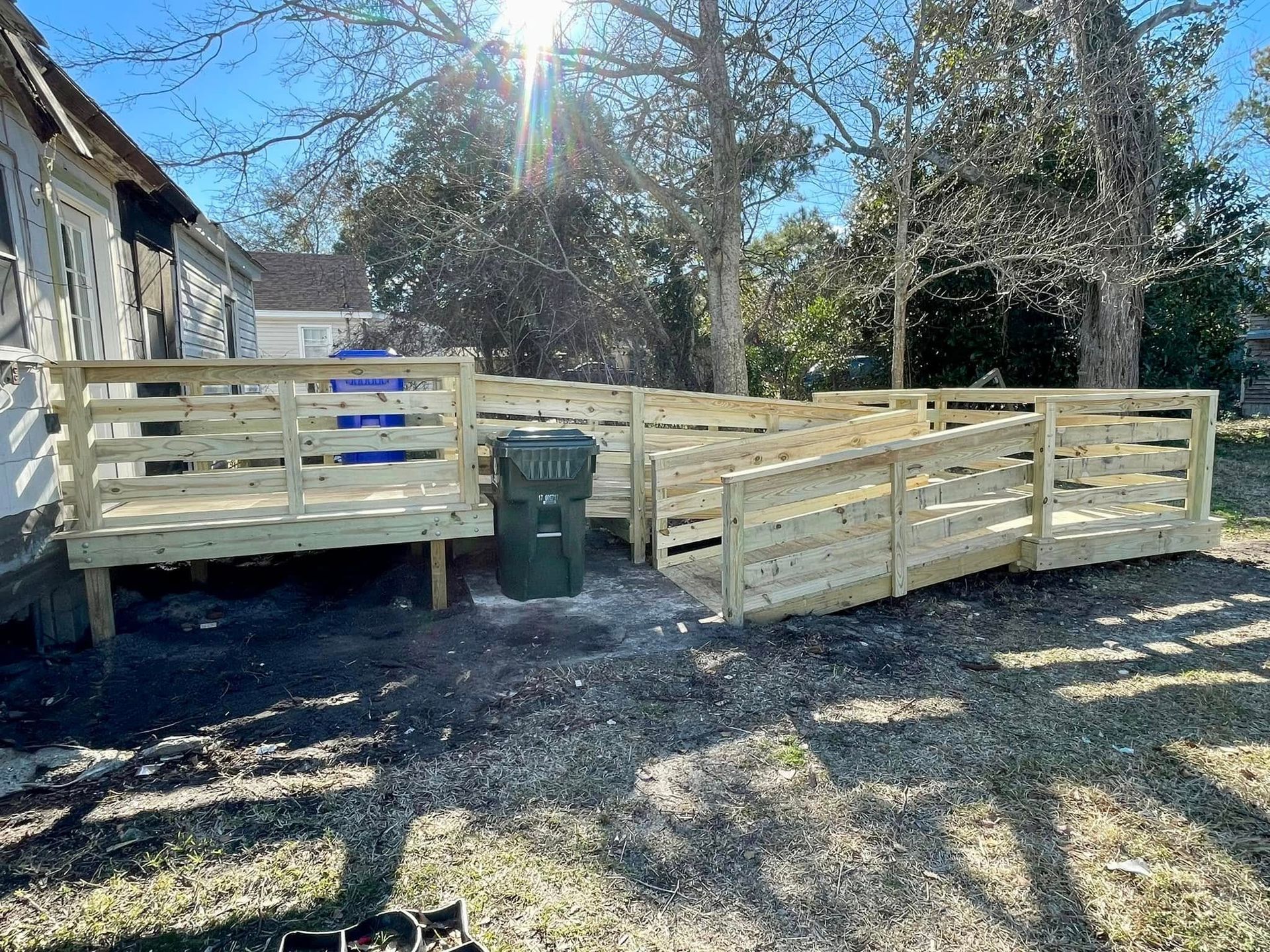 A wooden ramp is being built in front of a house.