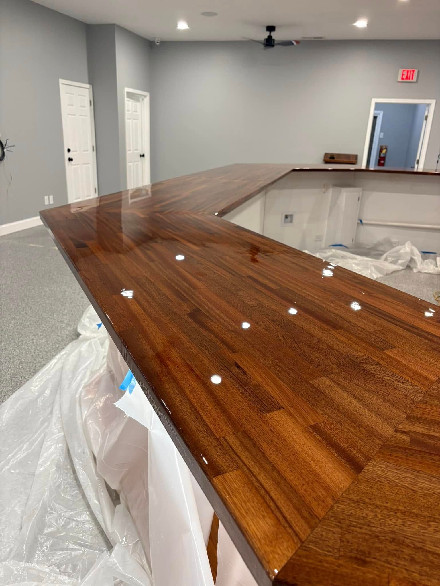 A wooden counter top in a room with a ceiling fan.