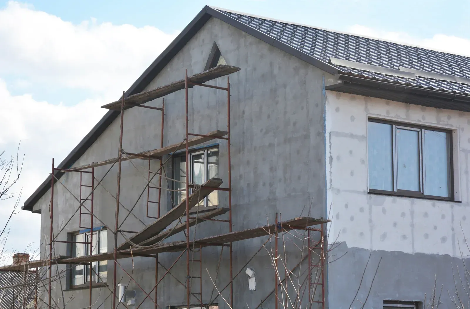 A house is being built with scaffolding around it.