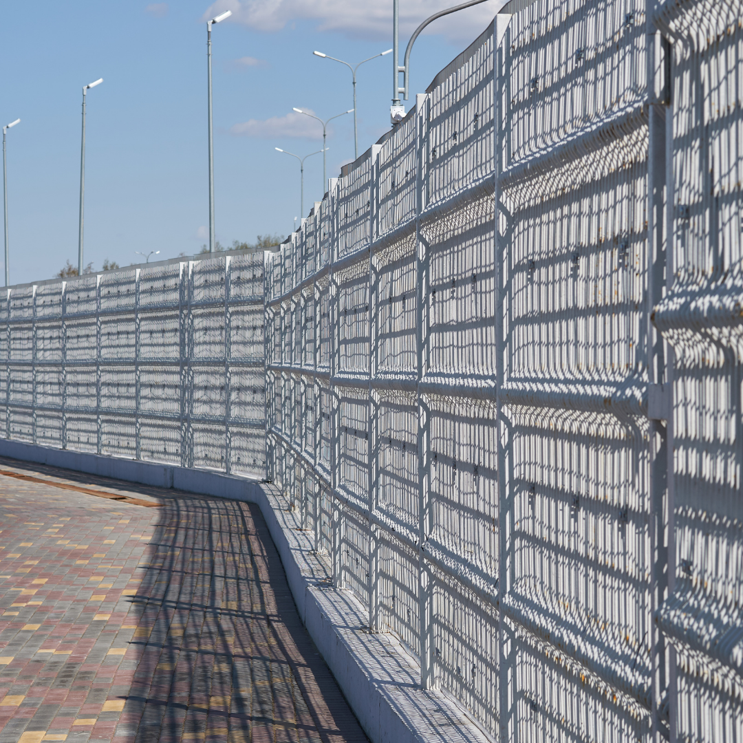 A fence with a shadow of a building on it