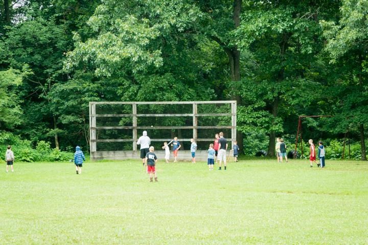 A group of children are playing soccer in a field.