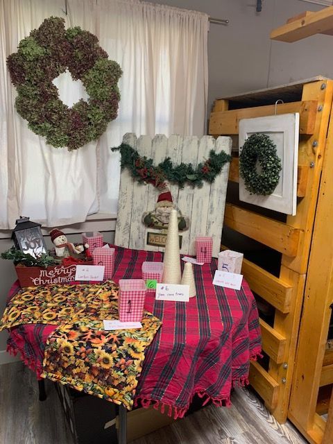 A table with a plaid tablecloth and christmas decorations on it.