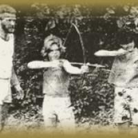 A group of people are standing next to each other holding bows and arrows.