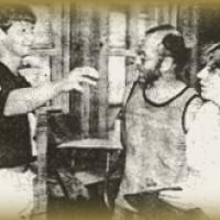 A group of people are standing next to each other in a room in a black and white photo.