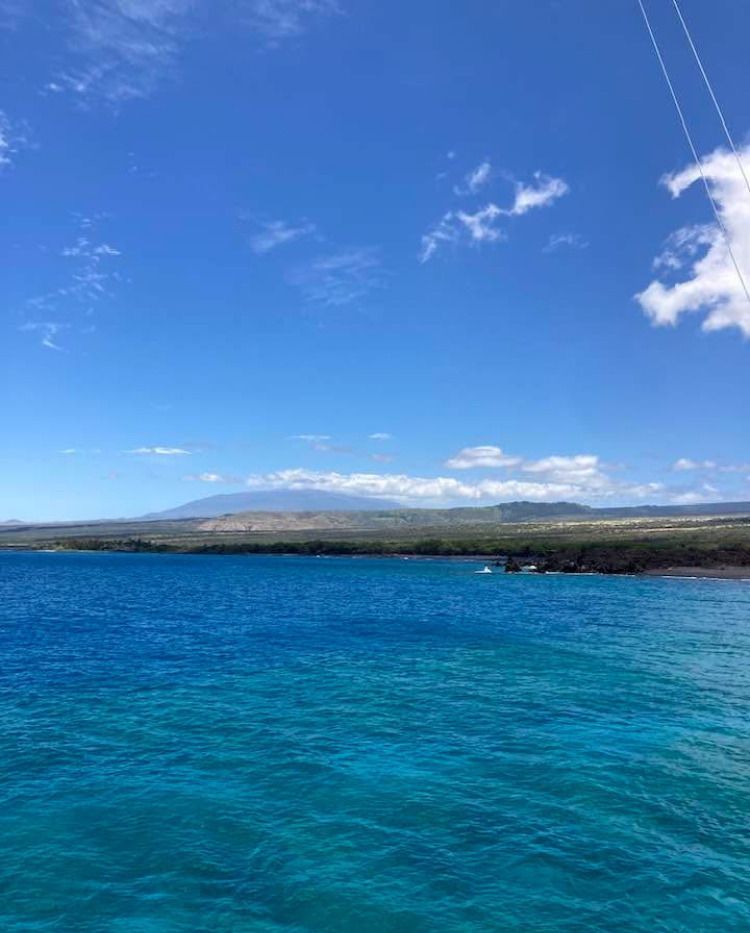 A sailboat is floating on top of a large body of water.