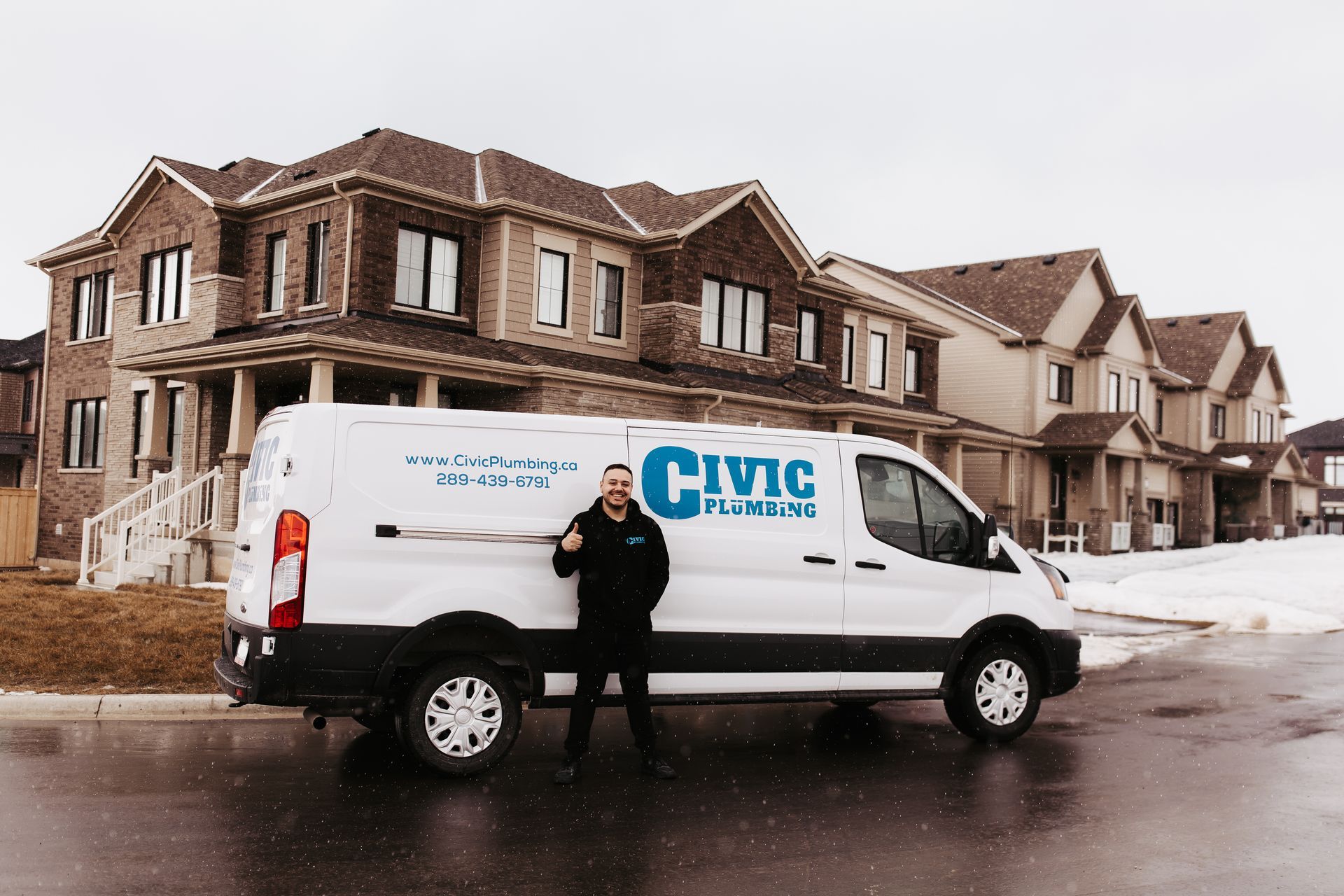 Man beside a Civic Plumbers van, thumbs up, in front of houses on a cloudy day.