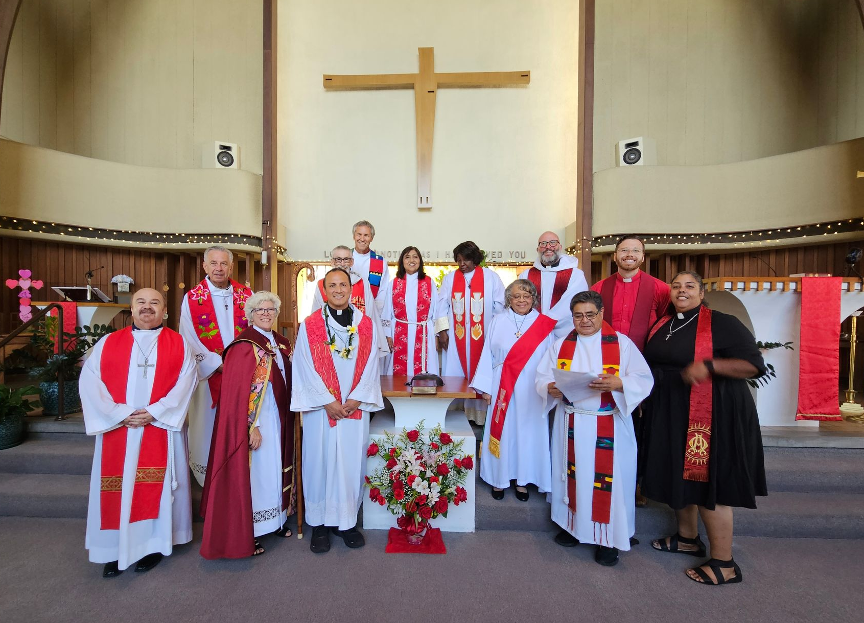 A group of priests are posing for a picture in a church.