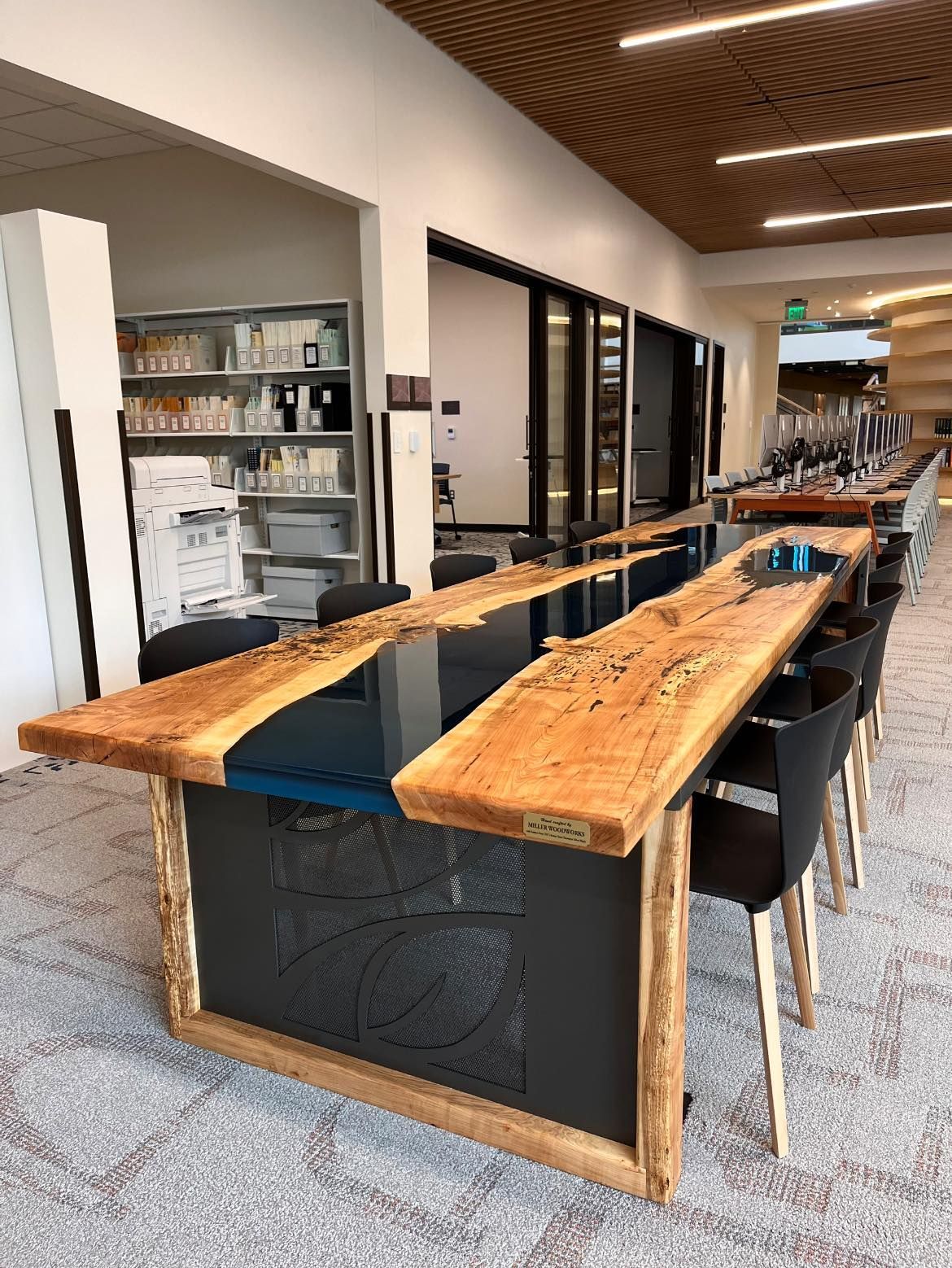 A long wooden table with chairs in a room.