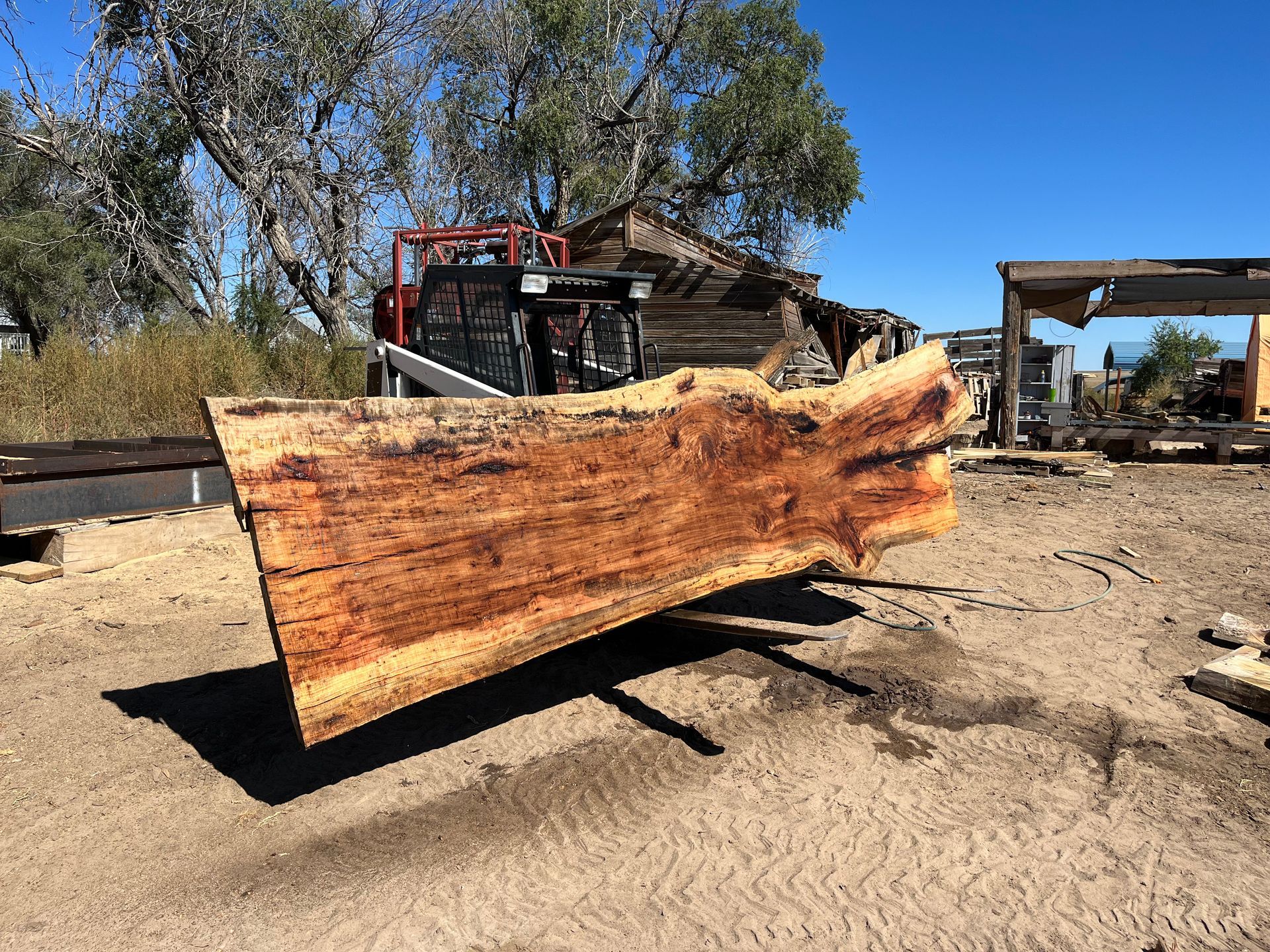 A large log is being cut by a machine