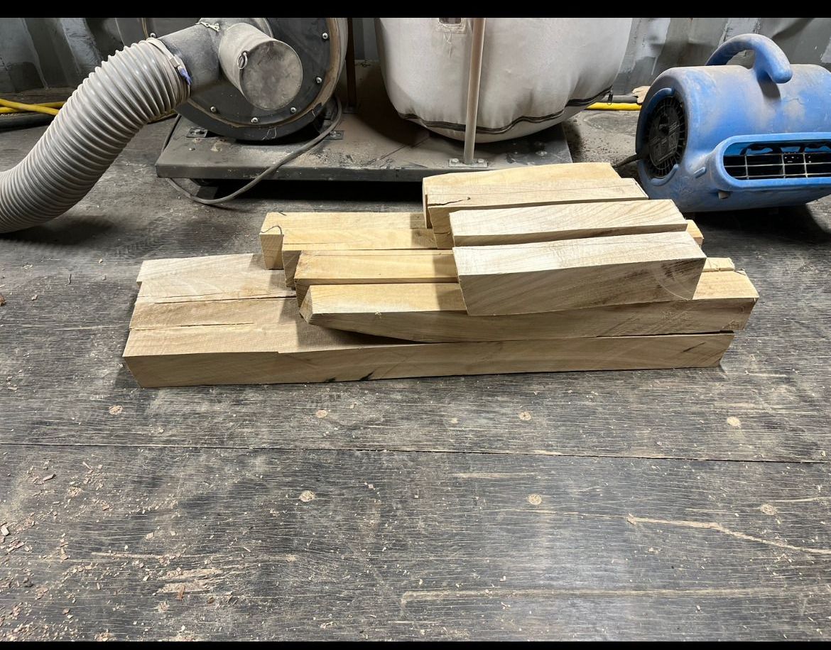 A large log is being cut by a machine