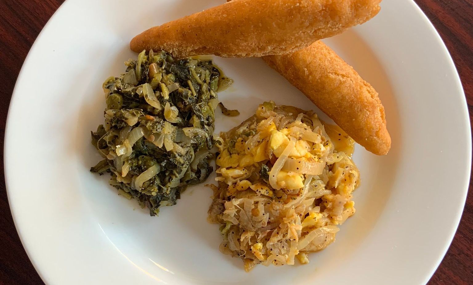 A white plate topped with three different types of food.