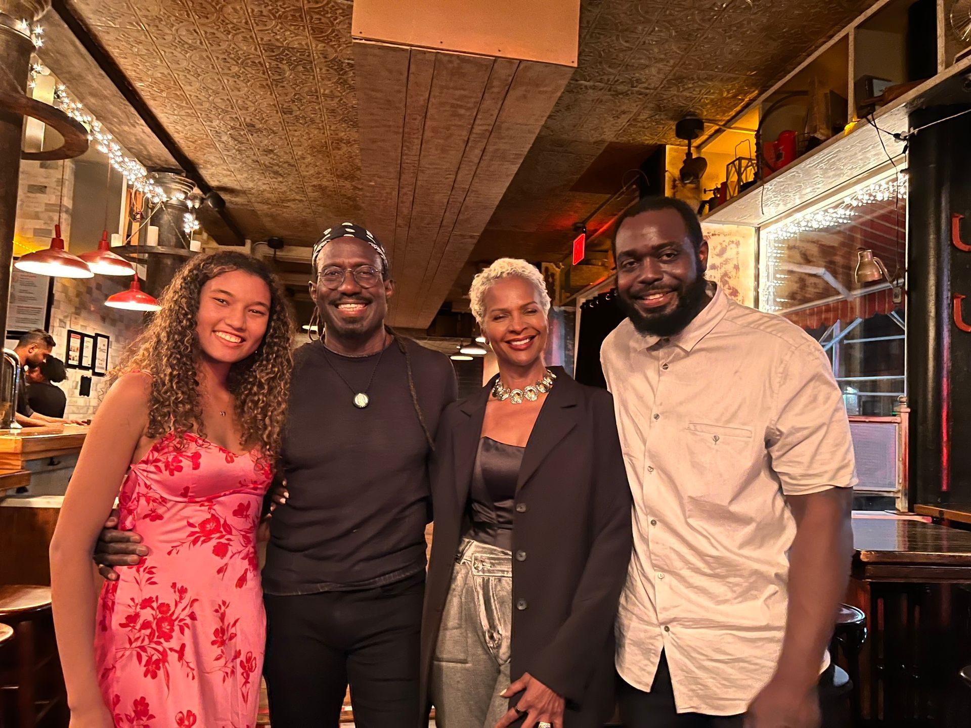 A group of people are posing for a picture in a restaurant.
