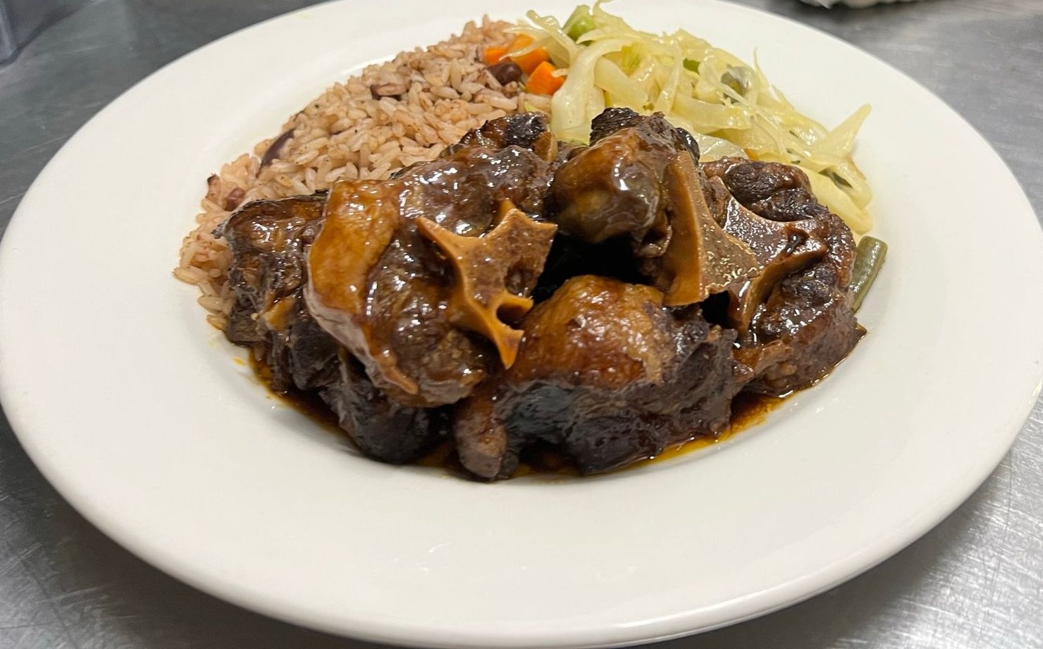 A plate of food with rice and vegetables on a table.