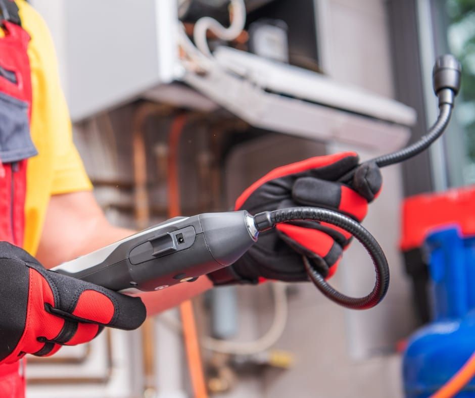 Car engine with black components and a yellow oil dipstick.