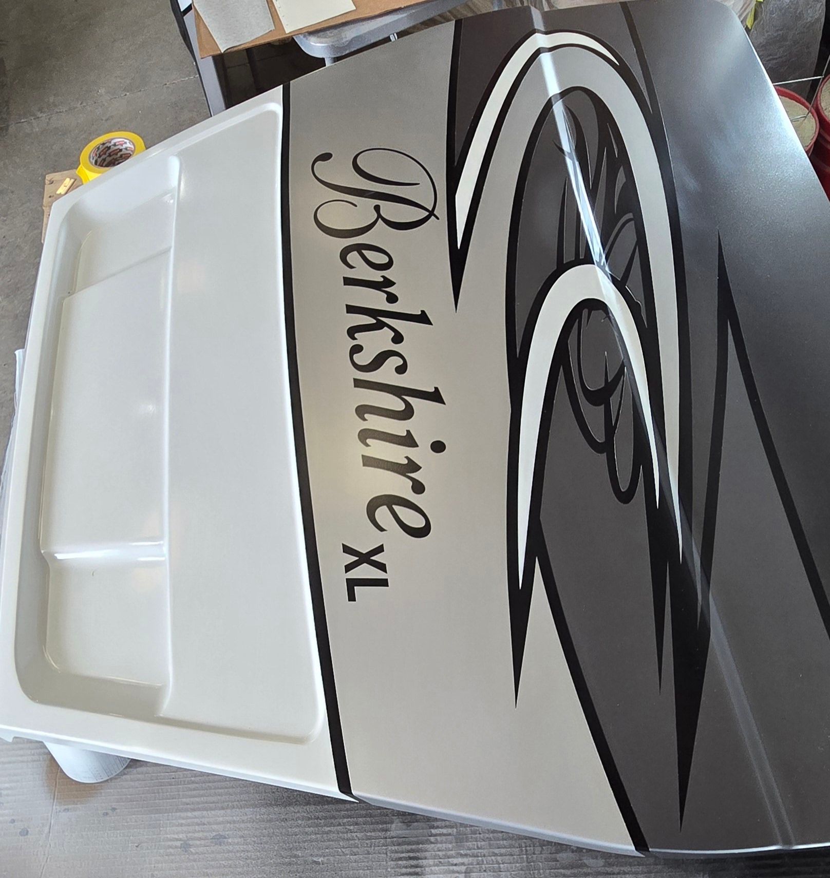 A white and gray panel with abstract black graphics and the text 