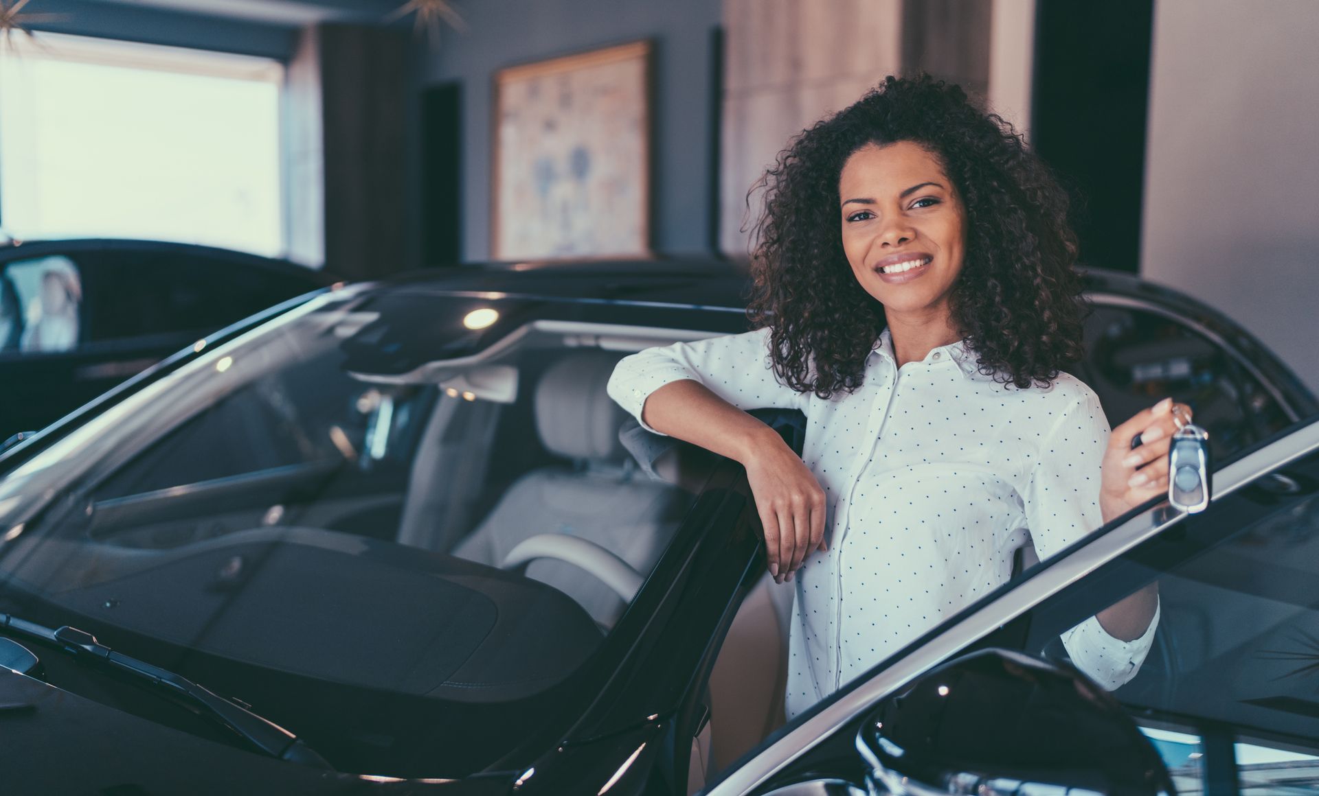 A Woman Is Standing Next to a Car — Lothian, MD — On The Spot Tag & Title
