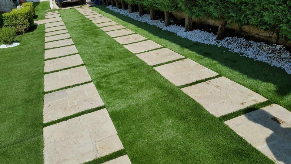 prato sintetico con camminamenti in pietra grigia