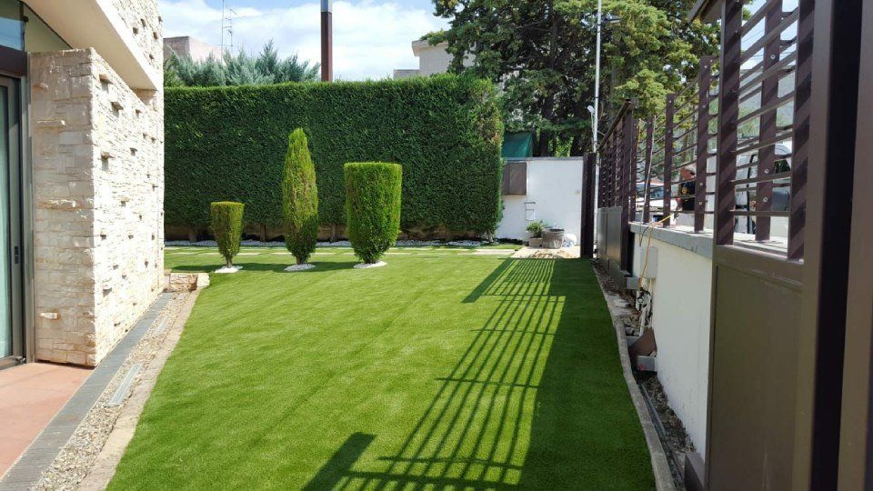 giardino con alberi ed erba sintetica