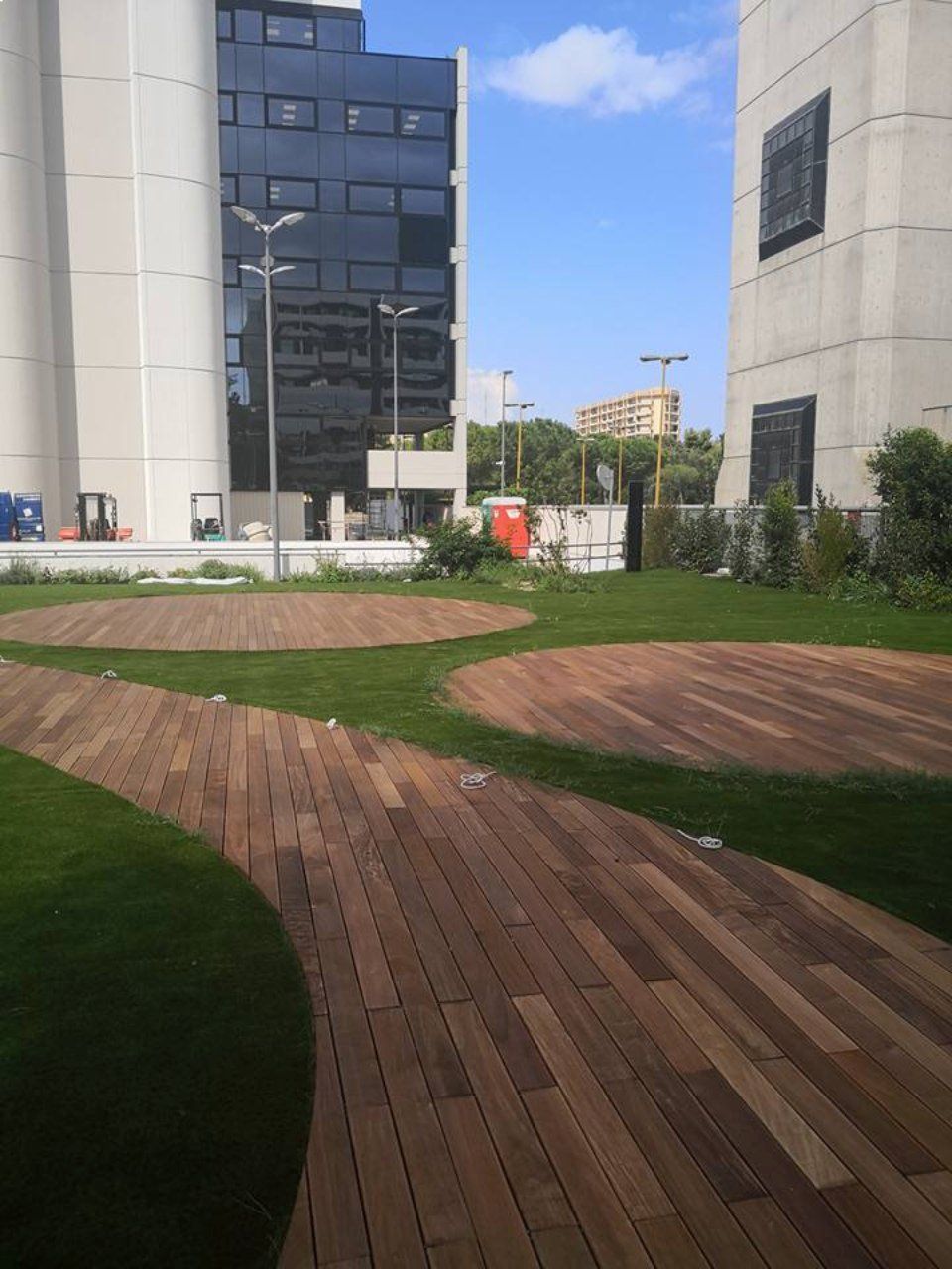 giardino con erba sintetica e piazzole in legno