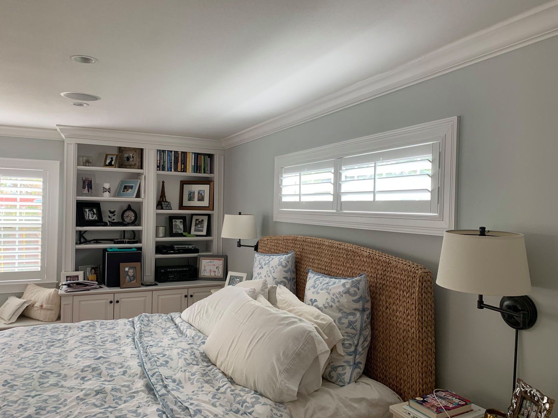 A bedroom with lamps, shelves and shutters — Deland, FL — Island Shutter Company