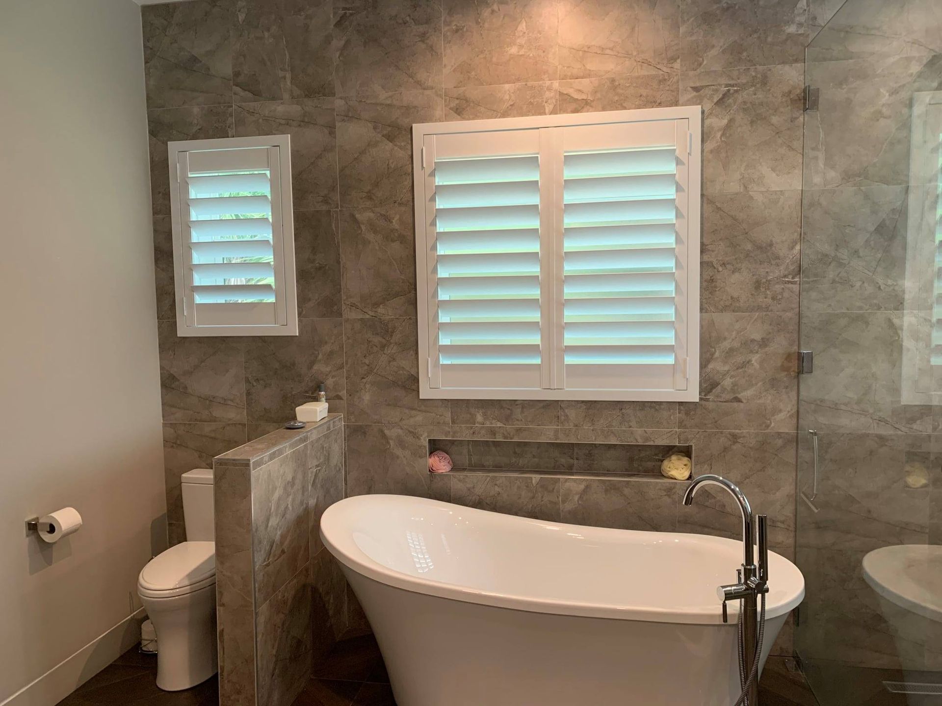 A bathroom with a tub, toilet and shower — Deland, FL — Island Shutter Company