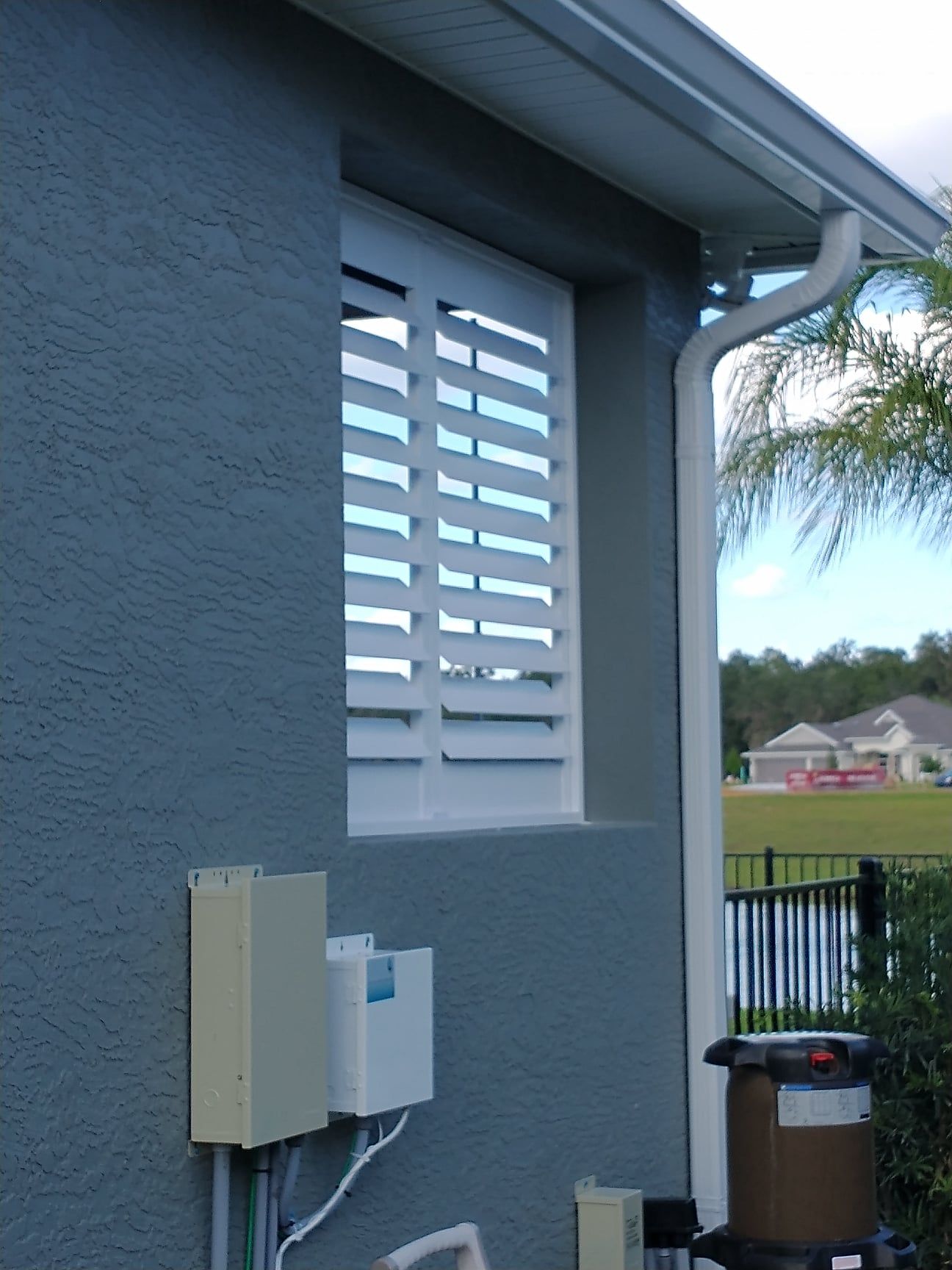 A window with shutters on the side of a house — Deland, FL — Island Shutter Company