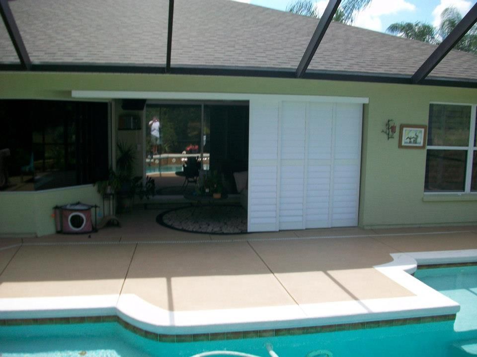 A house with a swimming pool and a sliding door — Deland, FL — Island Shutter Company