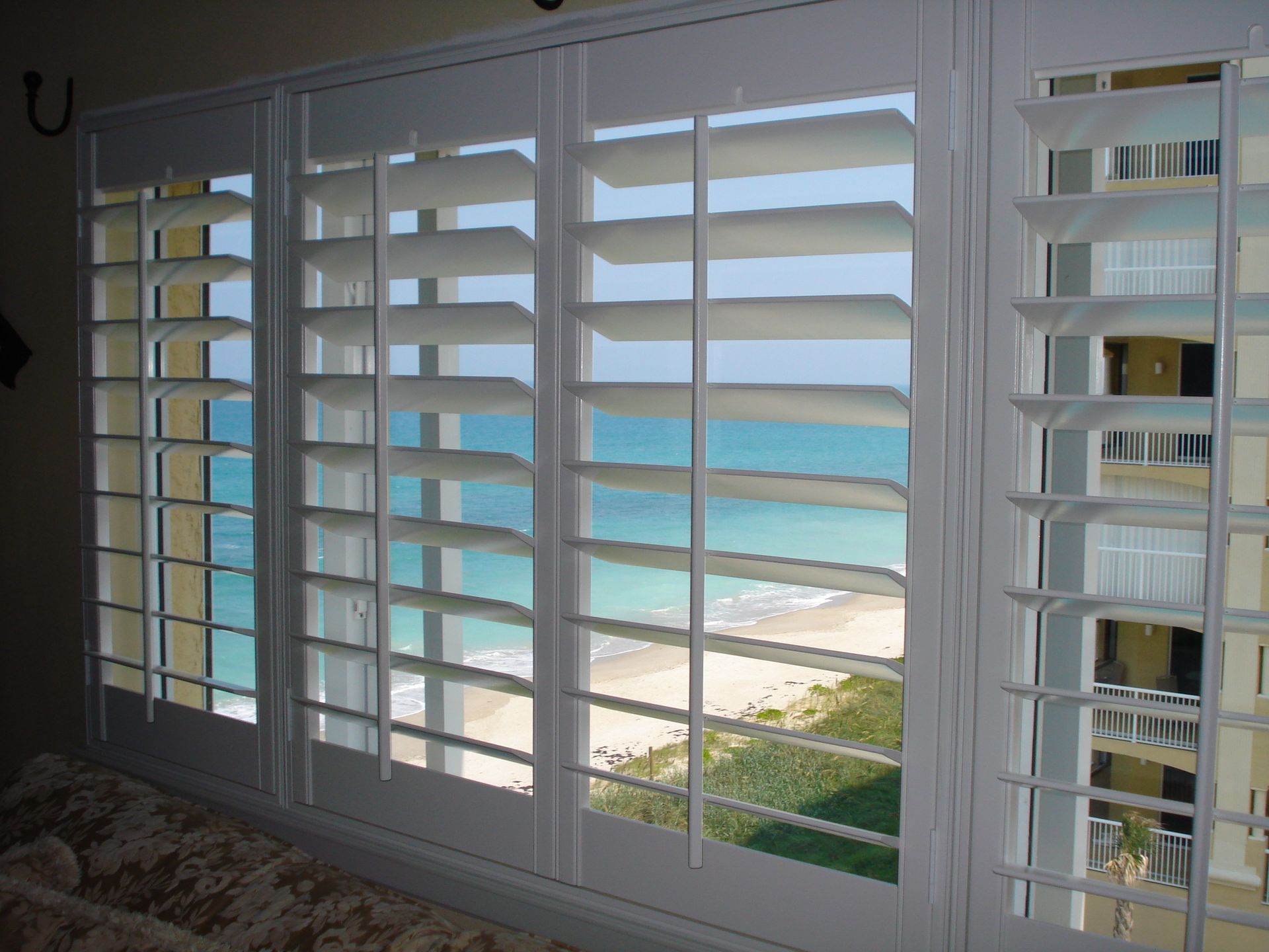 Close-up of an open window with shutters.
